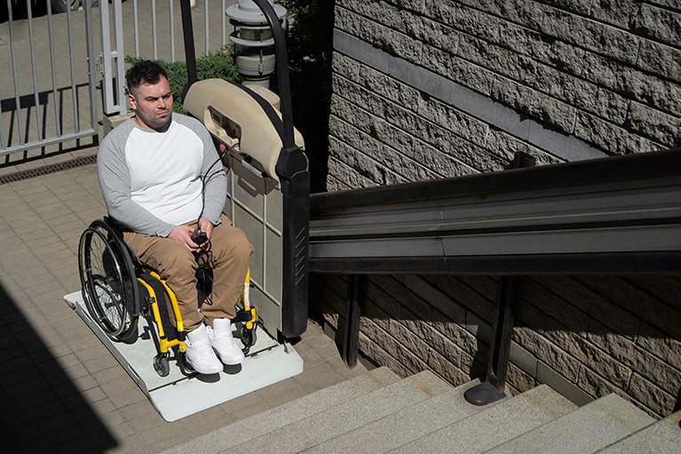 high-angle-man-wheelchair-outdoors-min