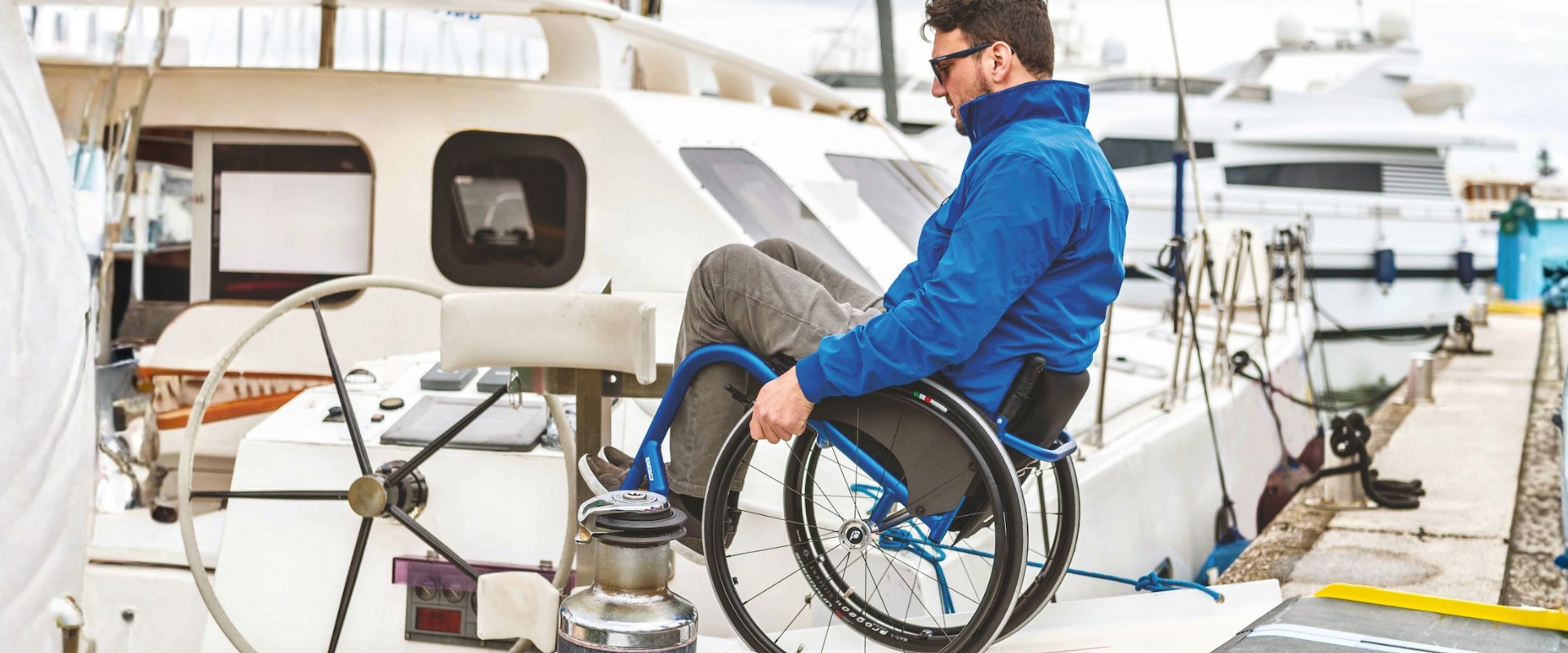 Woman in wheelchair smiling while other woman writing notes